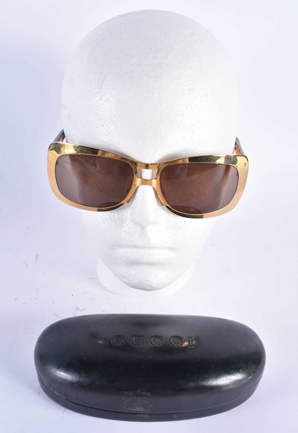A CASED PAIR OF GUCCI SUNGLASSES. 15 cm wide.
