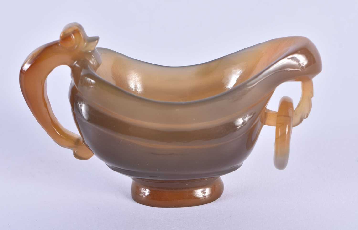 A 19TH CENTURY CHINESE CARVED AGATE LIBATION CUP Qing, of plain form with ring handle. 7.5 cm x 5