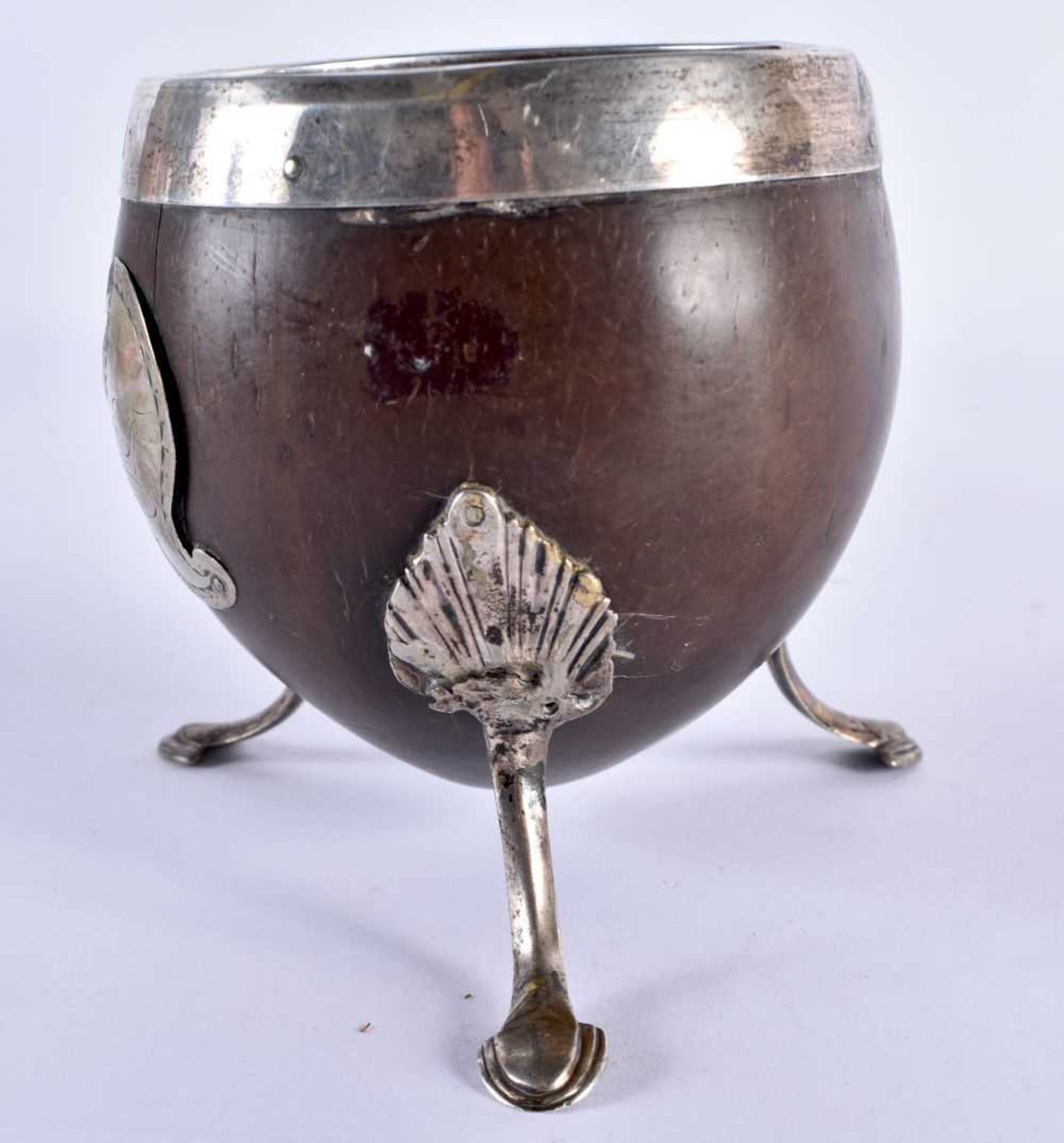 A GEORGE III WHITE METAL MOUNTED COCONUT CUP formed with a scrolling cartouche, upon splayed legs. - Image 2 of 5