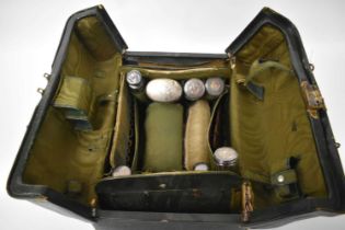 AN ANTIQUE CASED LEATHER AND SILVER TRAVELLING CASE with partially fitted interior. London 1910 etc.