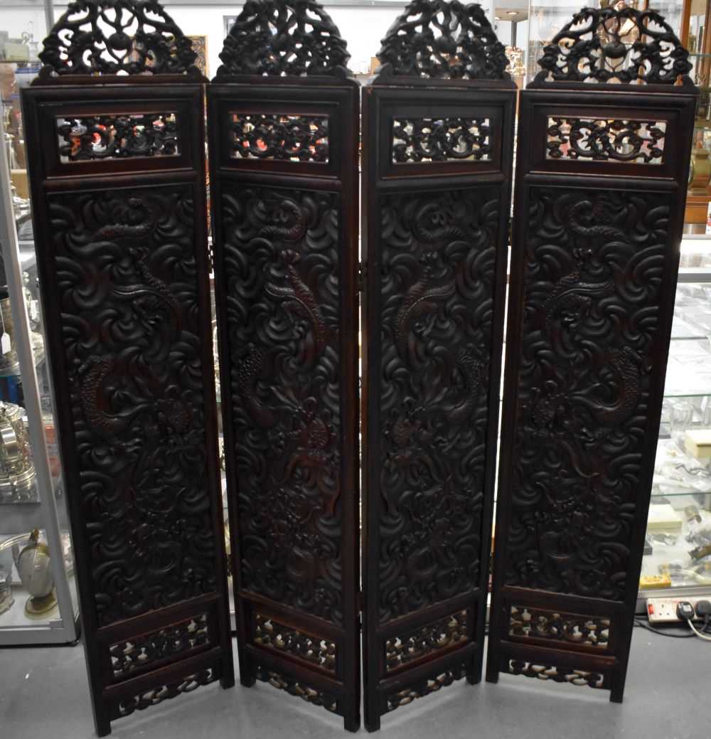 A LARGE 19TH CENTURY CHINESE CARVED HARDWOOD FOUR FOLD DRAGON SCREEN Qing. 142 cm x 136 cm.