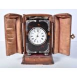 A Tortoiseshell Cased Carriage Alarm Clock with Silver Mounts in a fitted leather travelling