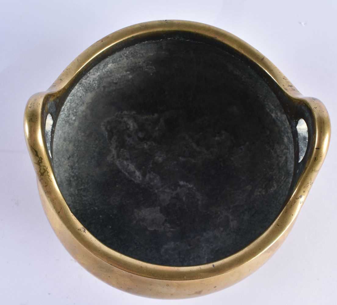 AN 18TH CENTURY CHINESE TWIN HANDLED BRONZE CENSER with high loop handles, bearing Xuande marks to - Image 6 of 7