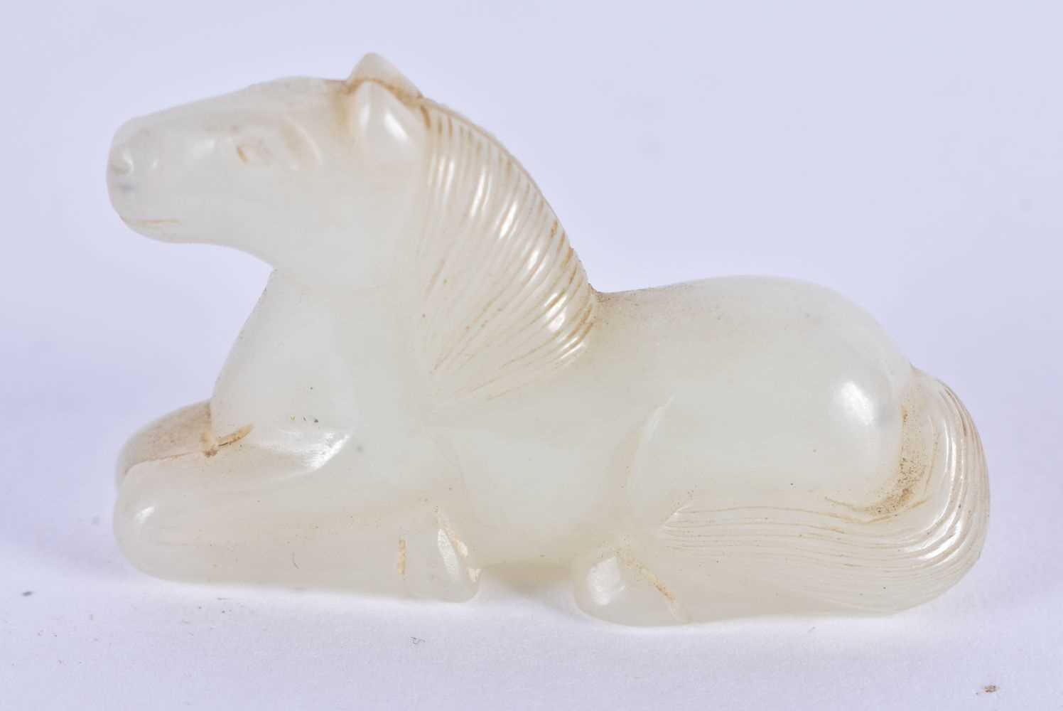 A 19TH CENTURY CHINESE CARVED WHITE JADE FIGURE OF A RECUMBANT HORSE Qing. 3 cm x 2 cm.