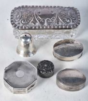 A Glass Trinket Box with Silver Lid together with 4 Silver Pill Boxes and a Silver Condiment.