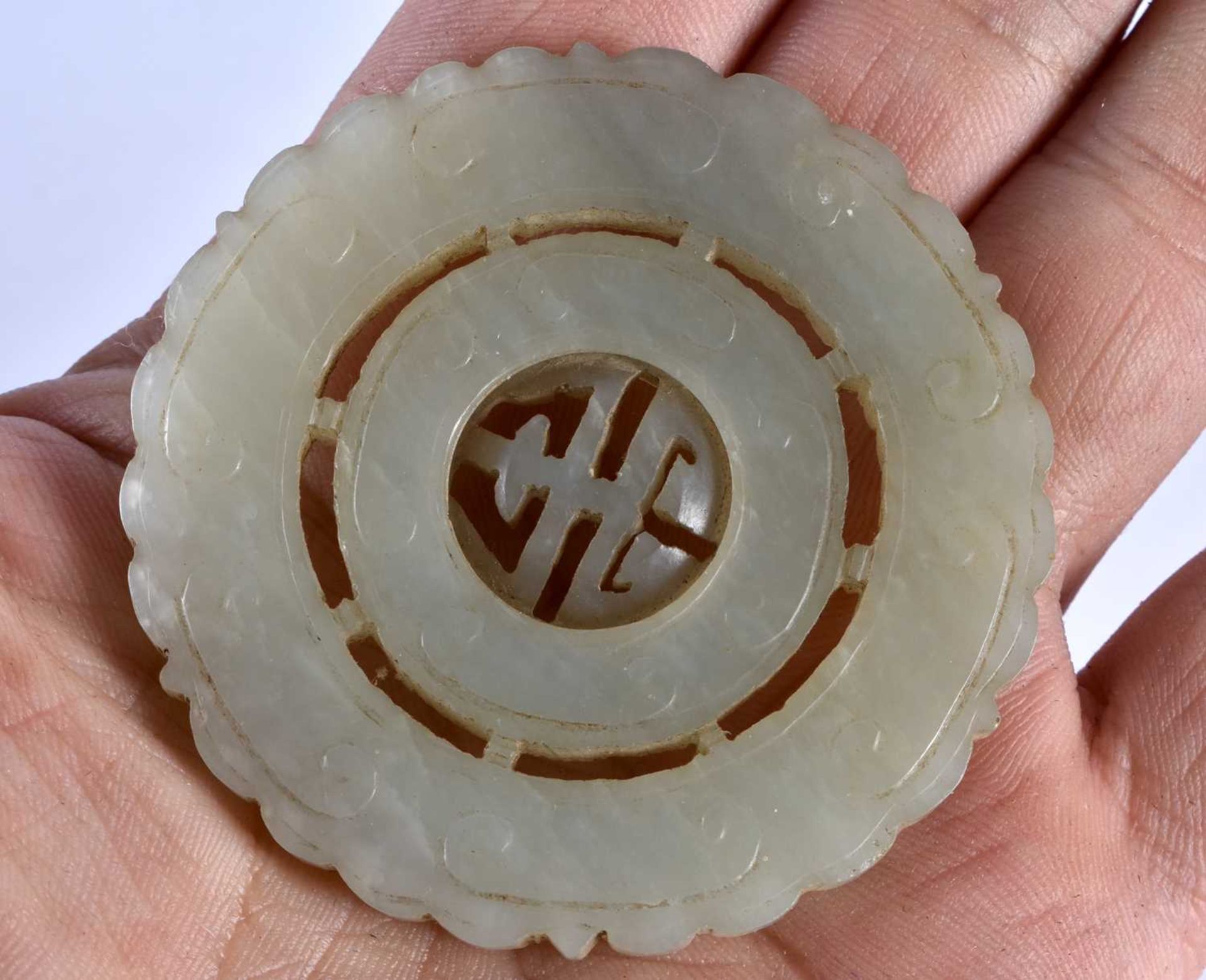 THREE 19TH CENTURY CHINESE GREEN JADE ROUNDELS Qing, in various forms. Jade 5 cm wide. (3) - Image 11 of 14