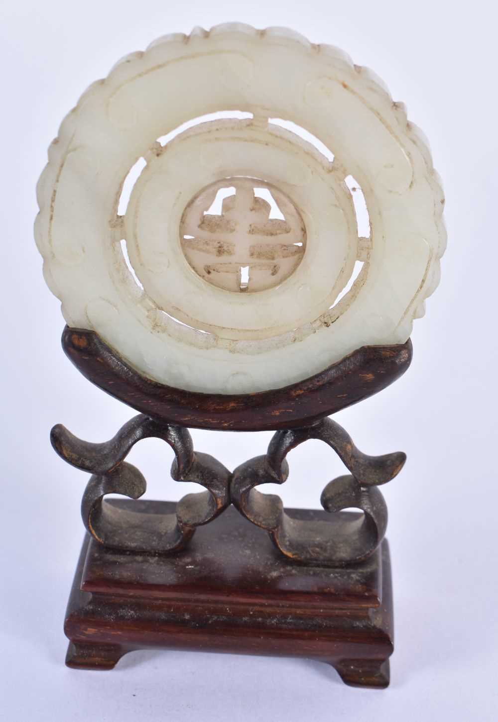 THREE 19TH CENTURY CHINESE GREEN JADE ROUNDELS Qing, in various forms. Jade 5 cm wide. (3) - Image 7 of 14