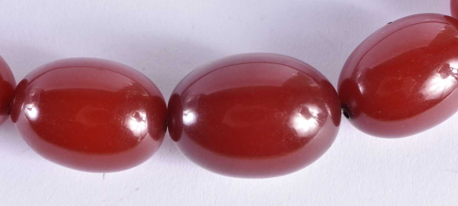 A CHERRY AMBER NECKLACE.69 grams. 84 cm long, largest bead 2.75 cm x 2.25 cm. - Image 2 of 6