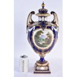 A FINE ROYAL WORCESTER TWIN HANDLED BLUE PORCELAIN VASE AND COVER painted with a landscape by
