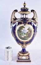 A FINE ROYAL WORCESTER TWIN HANDLED BLUE PORCELAIN VASE AND COVER painted with a landscape by