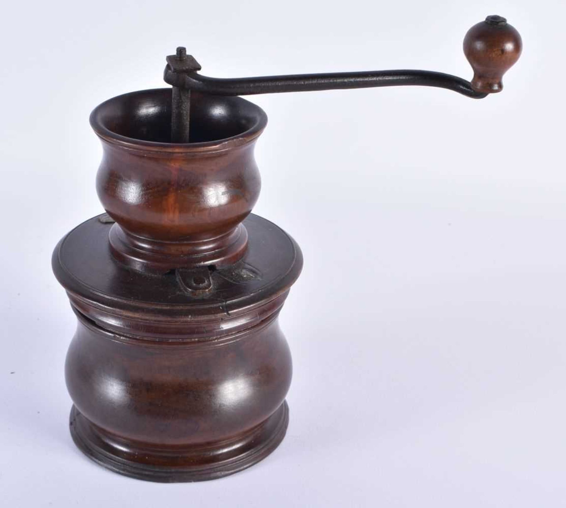 A GEORGE III CARVED TREEN COFFEE GRINDER with stylised iron handle. 19 cm x 14 cm. Note: The first