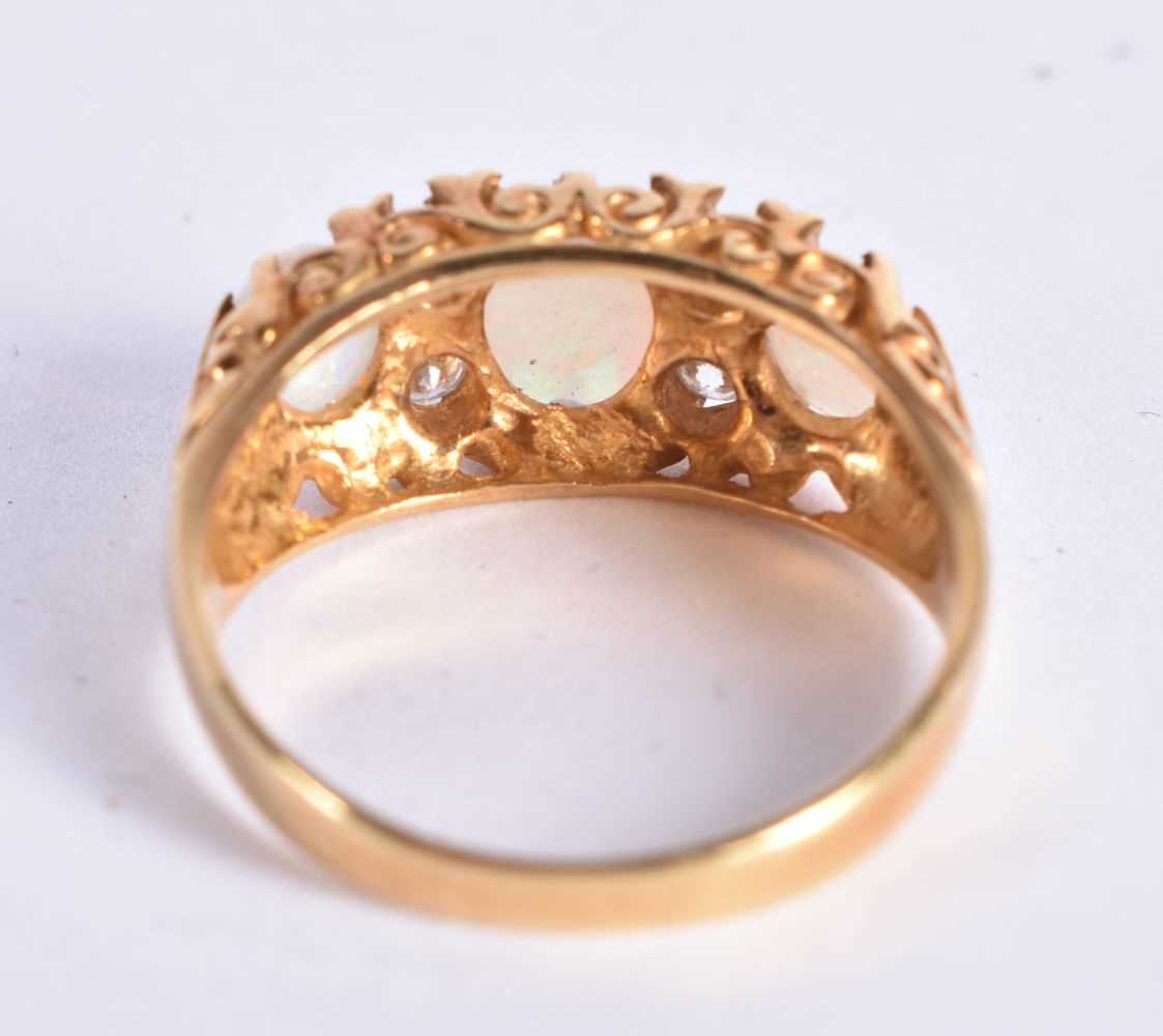 A 18 Carat Gold Ring Set with 3 Opals and 4 Diamonds. Stamped 18CT, Size P, weight 3.2g. - Image 3 of 4