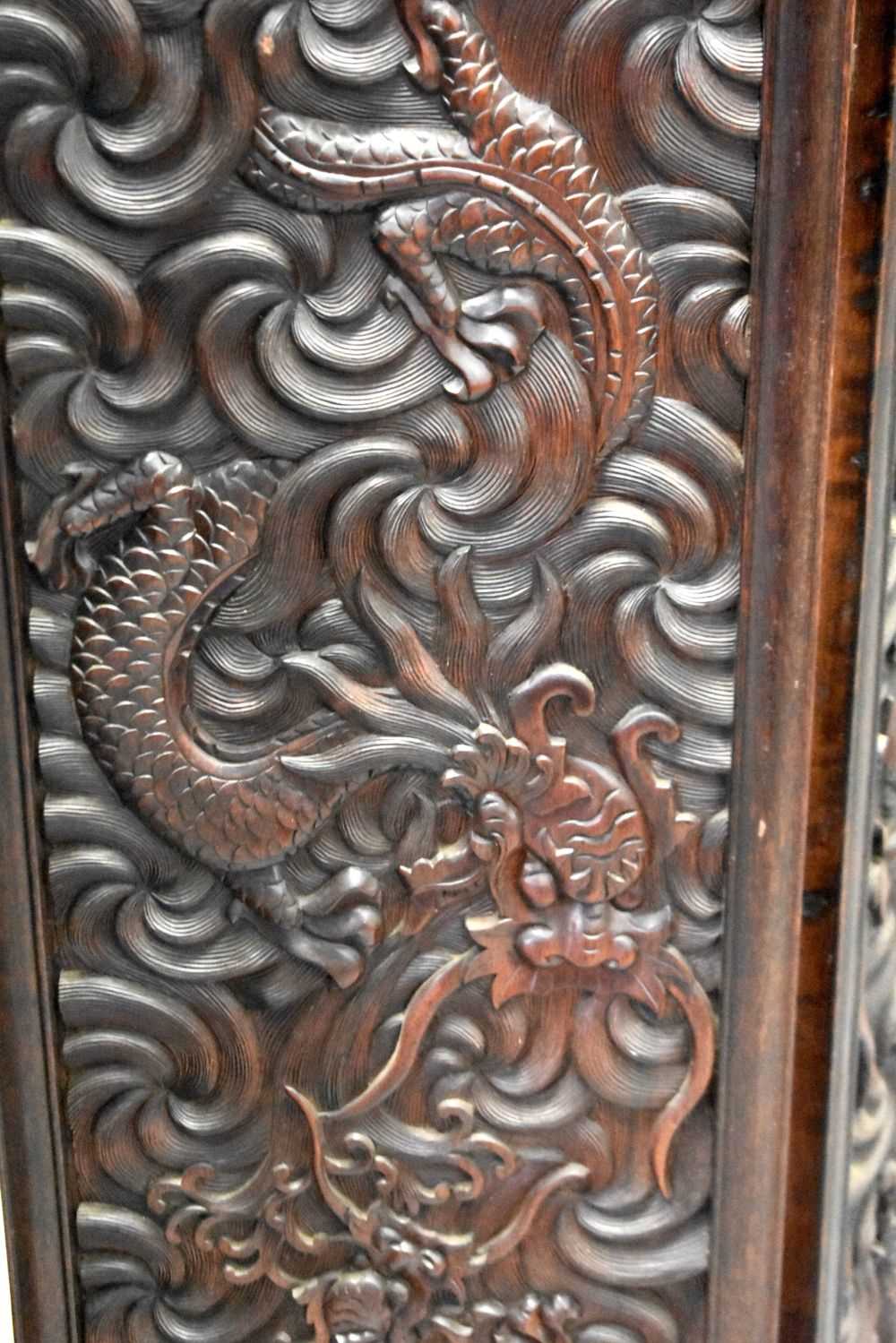 A LARGE 19TH CENTURY CHINESE CARVED HARDWOOD FOUR FOLD DRAGON SCREEN Qing. 142 cm x 136 cm. - Image 6 of 13