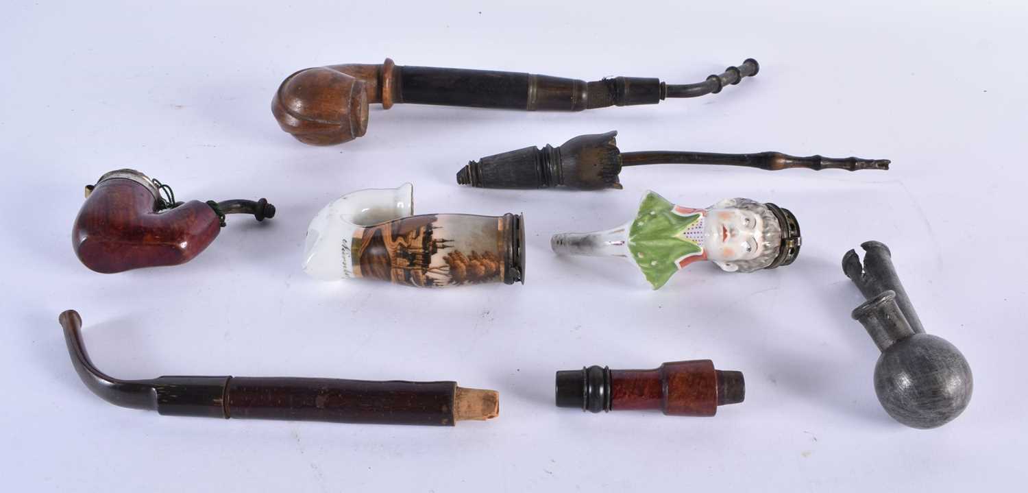 AN EARLY 19TH CENTURY ENGLISH PORCELAIN HEADED PIPE together with other pipes. Largest 30 cm