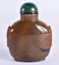 A 19TH CENTURY CHINESE CARVED AGATE SNUFF BOTTLE Qing, with jade stopper. 7.5 cm x 5.5 cm.