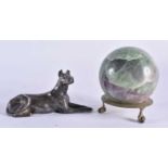 AN ANTIQUE ENGLISH SILVER PLATED RECUMBANT HOUND together with a hardstone ball on stand. Largest 12