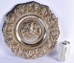 A LARGE 19TH CENTURY INDIAN SILVER REPOUSSE DISH depicting figures on elephants and fighting