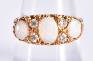 A 18 Carat Gold Ring Set with 3 Opals and 4 Diamonds. Stamped 18CT, Size P, weight 3.2g.