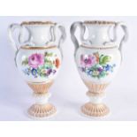A LARGE PAIR OF EARLY 20TH CENTURY GERMAN TWIN HANDLED MEISSEN PORCELAIN VASES painted with floral