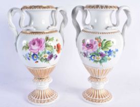 A LARGE PAIR OF EARLY 20TH CENTURY GERMAN TWIN HANDLED MEISSEN PORCELAIN VASES painted with floral