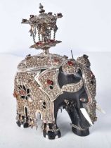 A Carved Wooden Elephant with Silver and Bone Decoration set with gems. Stamped 925, 10cm x 6.5cm