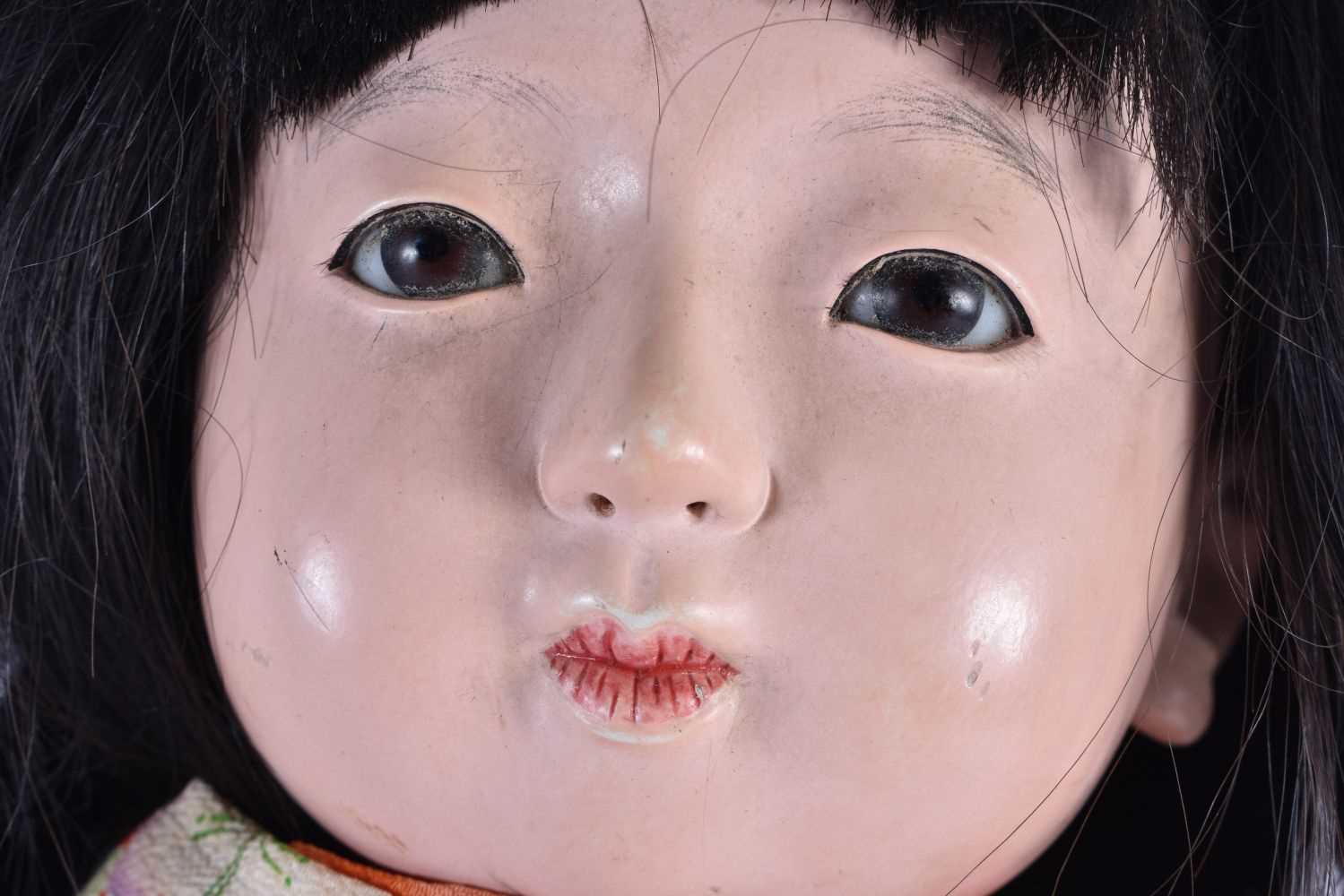 A JAPANESE TAISHO PERIOD SILK EMBROIDERED FRIENDSHIP DOLL with glass eyes and human hair. 64 cm - Image 2 of 5