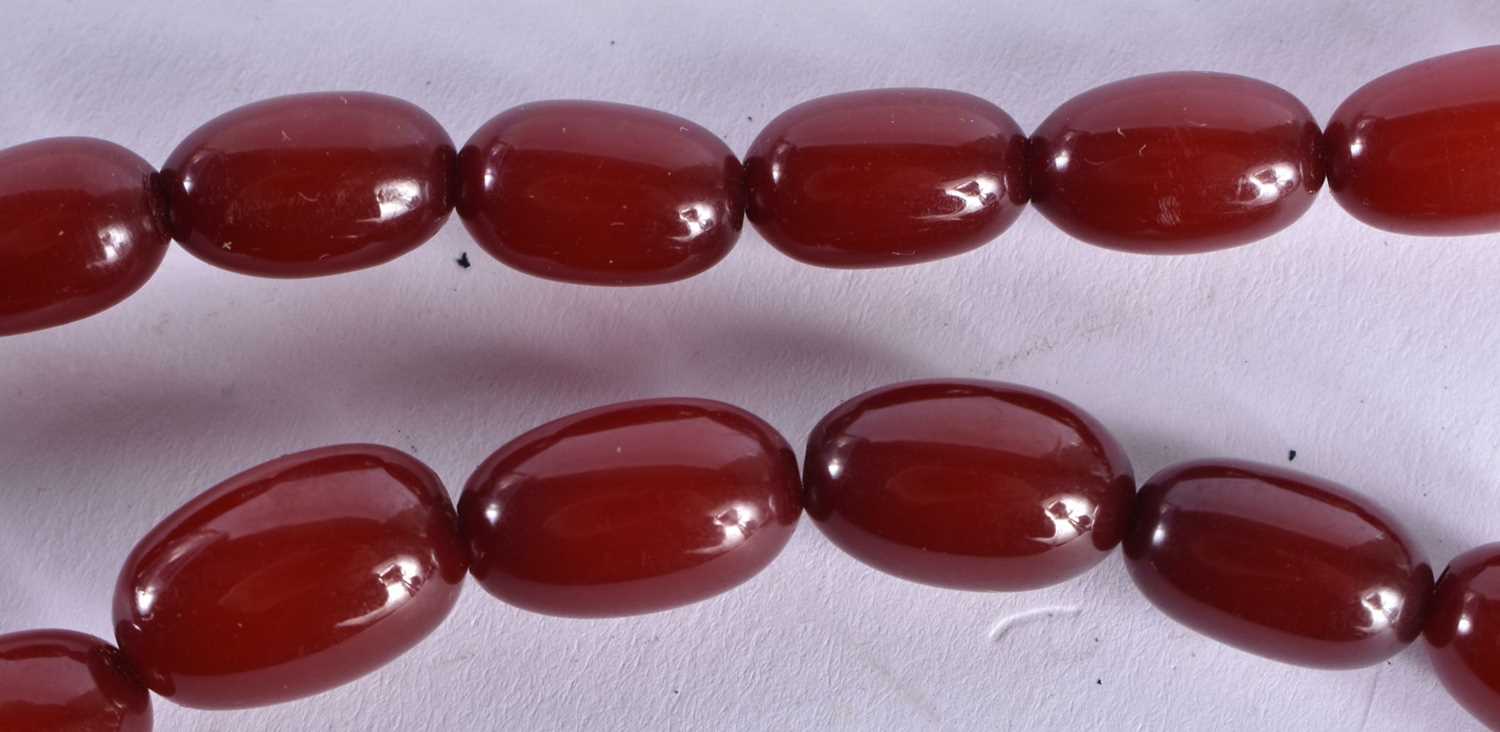 A CHERRY AMBER NECKLACE.69 grams. 84 cm long, largest bead 2.75 cm x 2.25 cm. - Image 3 of 6