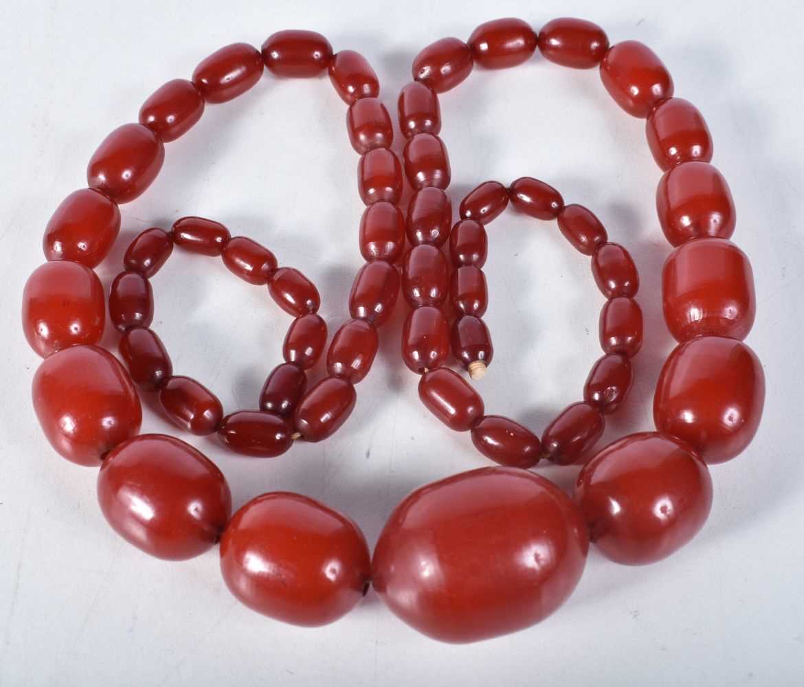 Cherry Bakelite graduated necklace with internal streaking. 99cm long, largest bead 30mm (165g)