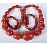 Cherry Bakelite graduated necklace with internal streaking. 99cm long, largest bead 30mm (165g)