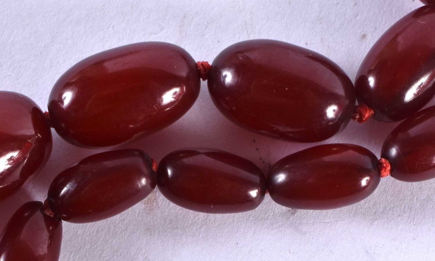 A Graduated Cherry Amber Bead Necklace. 78cm long, largest bead 23mm, smallest bead 7mm, total - Bild 4 aus 8