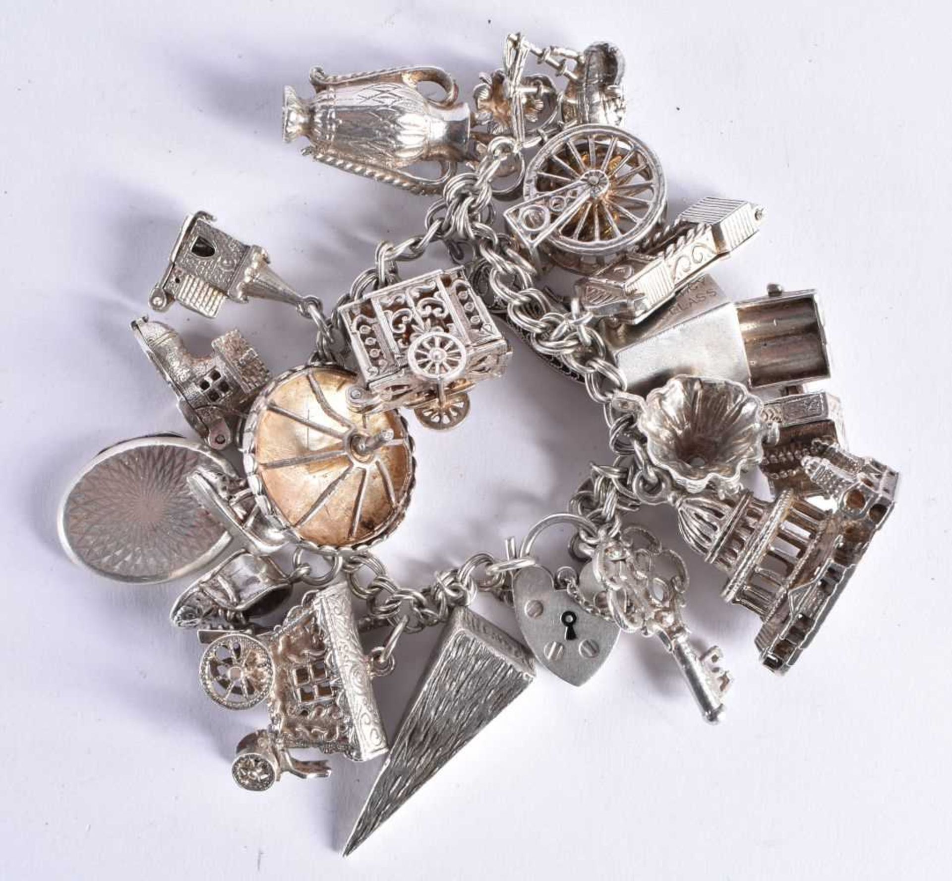 Silver charm bracelet including souvenir charms. 93.6 grams. 20 cm long.