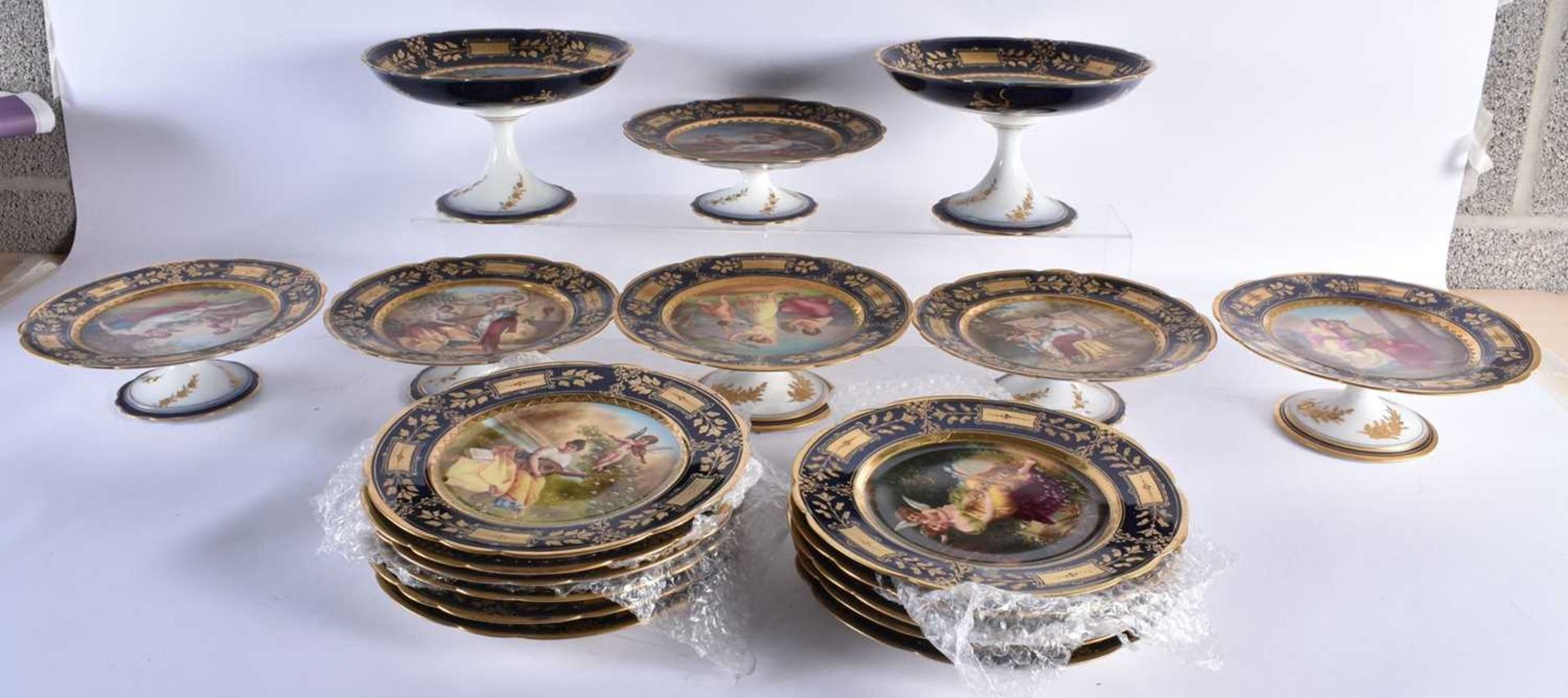 A GOOD EARLY 20TH CENTURY VIENNA PORCELAIN DESSERT SERVICE C1900 painted with figures and landscapes