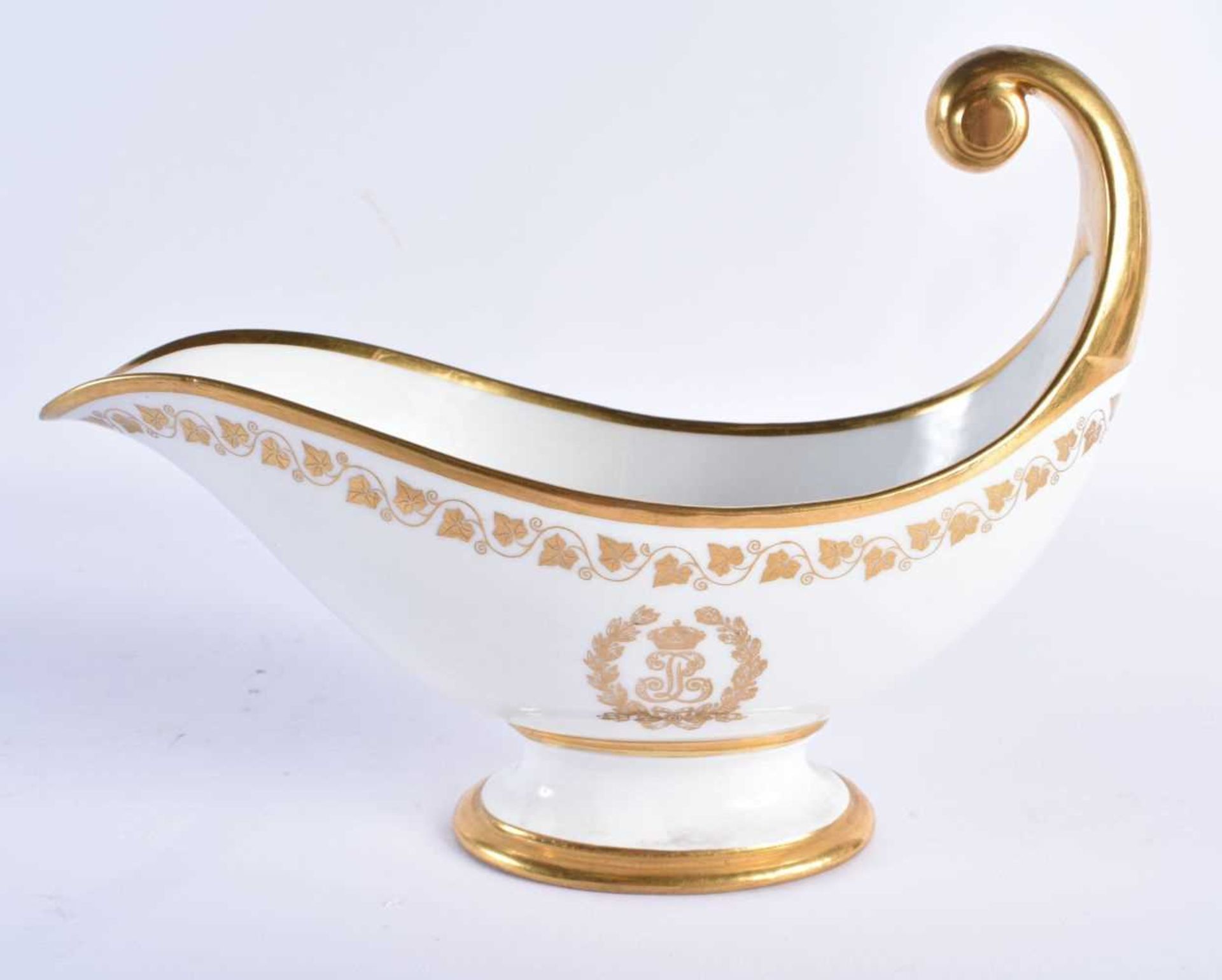 A LATE 19TH CENTURY FRENCH SEVRES PORCELAIN SAUCE BOAT painted with gilded flowers and trailing