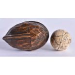 AN EXTREMELY RARE ANTIQUE CARVED NUT GLOBE the body rotating to reveal a tiny pocket globe. Nut 6 cm