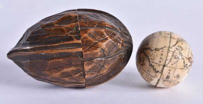 AN EXTREMELY RARE ANTIQUE CARVED NUT GLOBE the body rotating to reveal a tiny pocket globe. Nut 6 cm