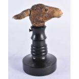 A VERY RARE 19TH CENTURY EUROPEAN CARVED ARTICULATED DONKEY HEAD formed upon an ebonised base,
