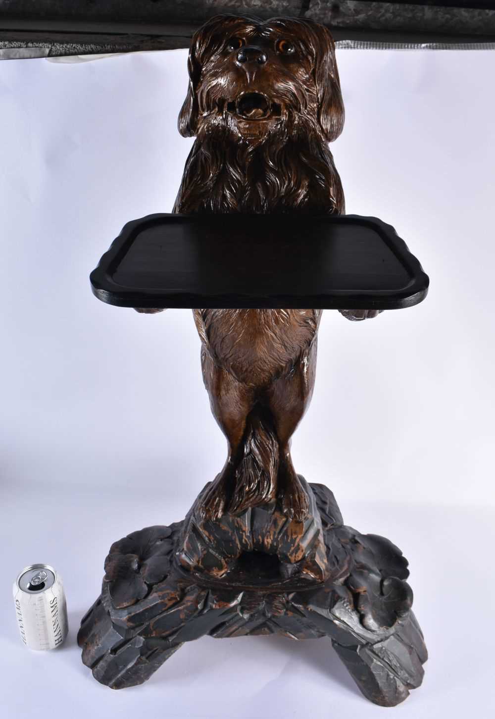 A LARGE 19TH CENTURY BAVARIAN BLACK FOREST CARVED WOOD BEGGING DOG STAND modelled with glass eyes,
