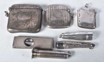 Three Silver Vesta Cases with Three Silver Cheroot Holders and a Silver Cigar Cutter. Various