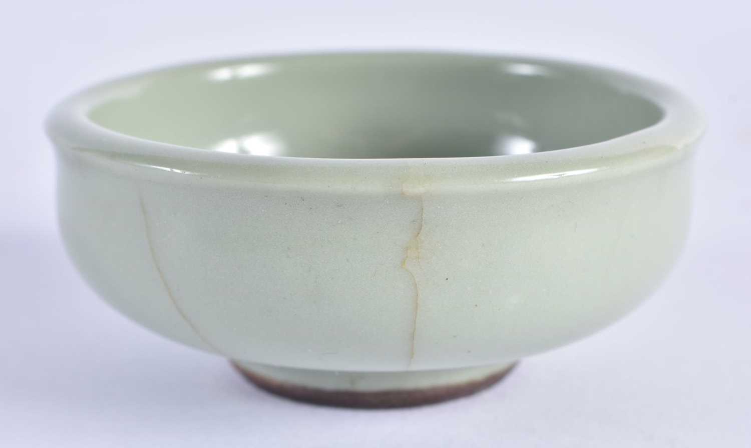 A CHINESE MING DYNASTY CELADON CIRCULAR DISH together with a Qing dynasty guan type bowl. Largest 14 - Image 5 of 7