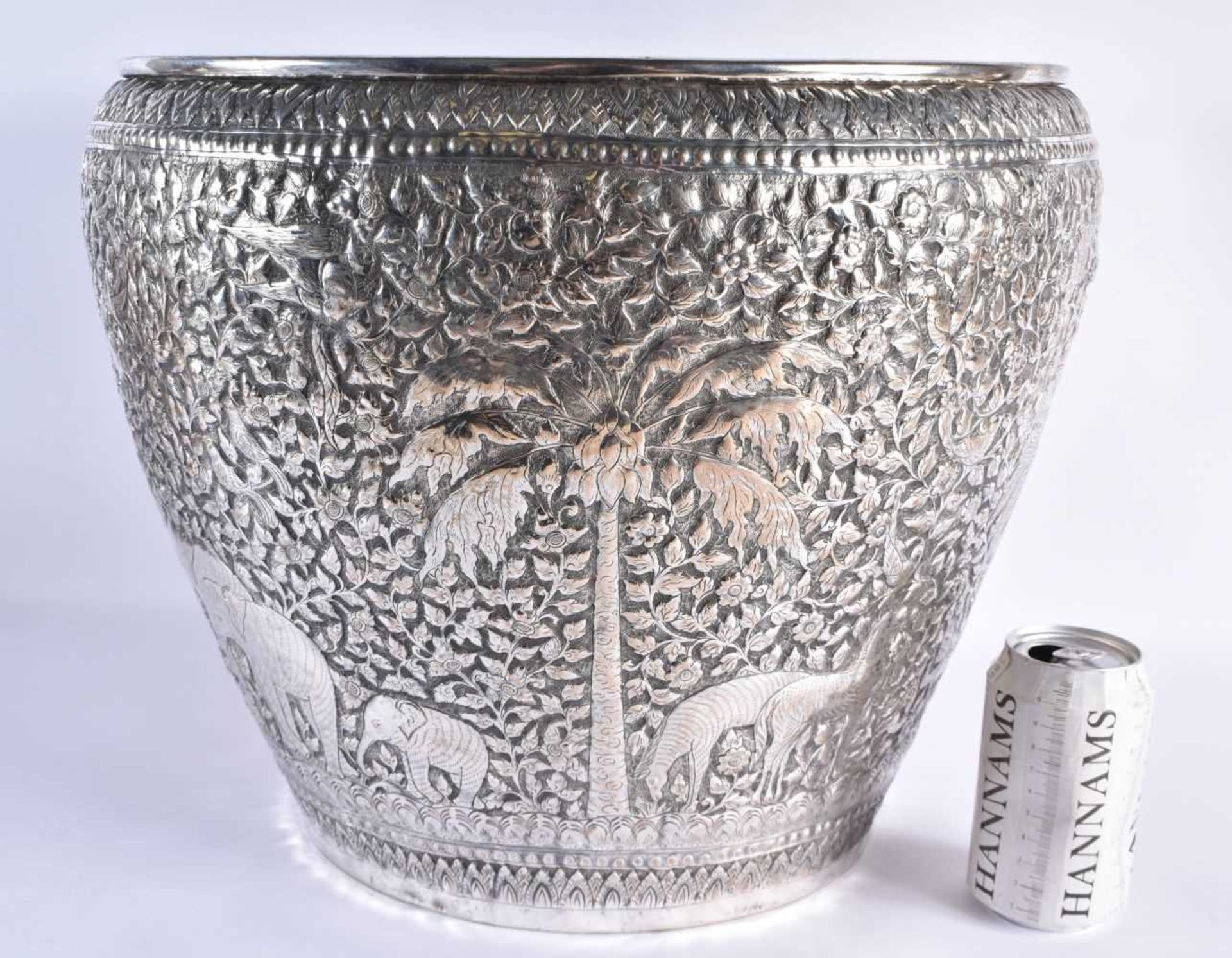 A VERY LARGE LATE 19TH CENTURY INDIAN WHITE METAL JARDINIERE decorative with animals and palm trees,