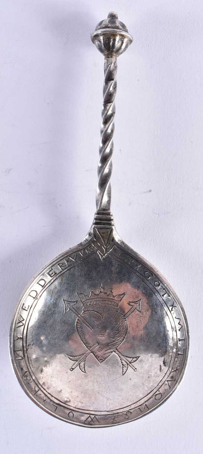 A RARE 17TH CENTURY GERMAN SILVER SPOON with wyvern twisted handle, the bowl engraved with a motto