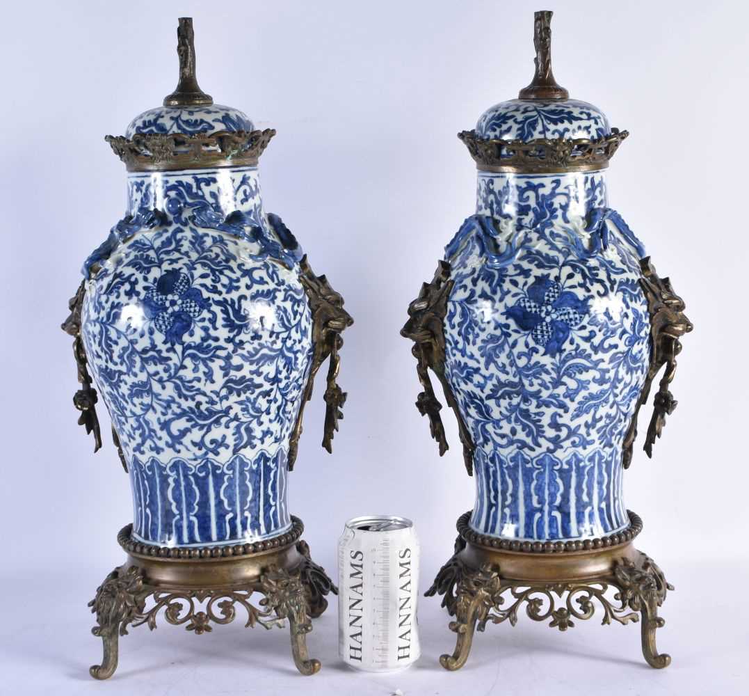 A LARGE PAIR OF 19TH CENTURY CHINESE BLUE AND WHITE BRONZE MOUNTED VASES Qing. 48 cm high.
