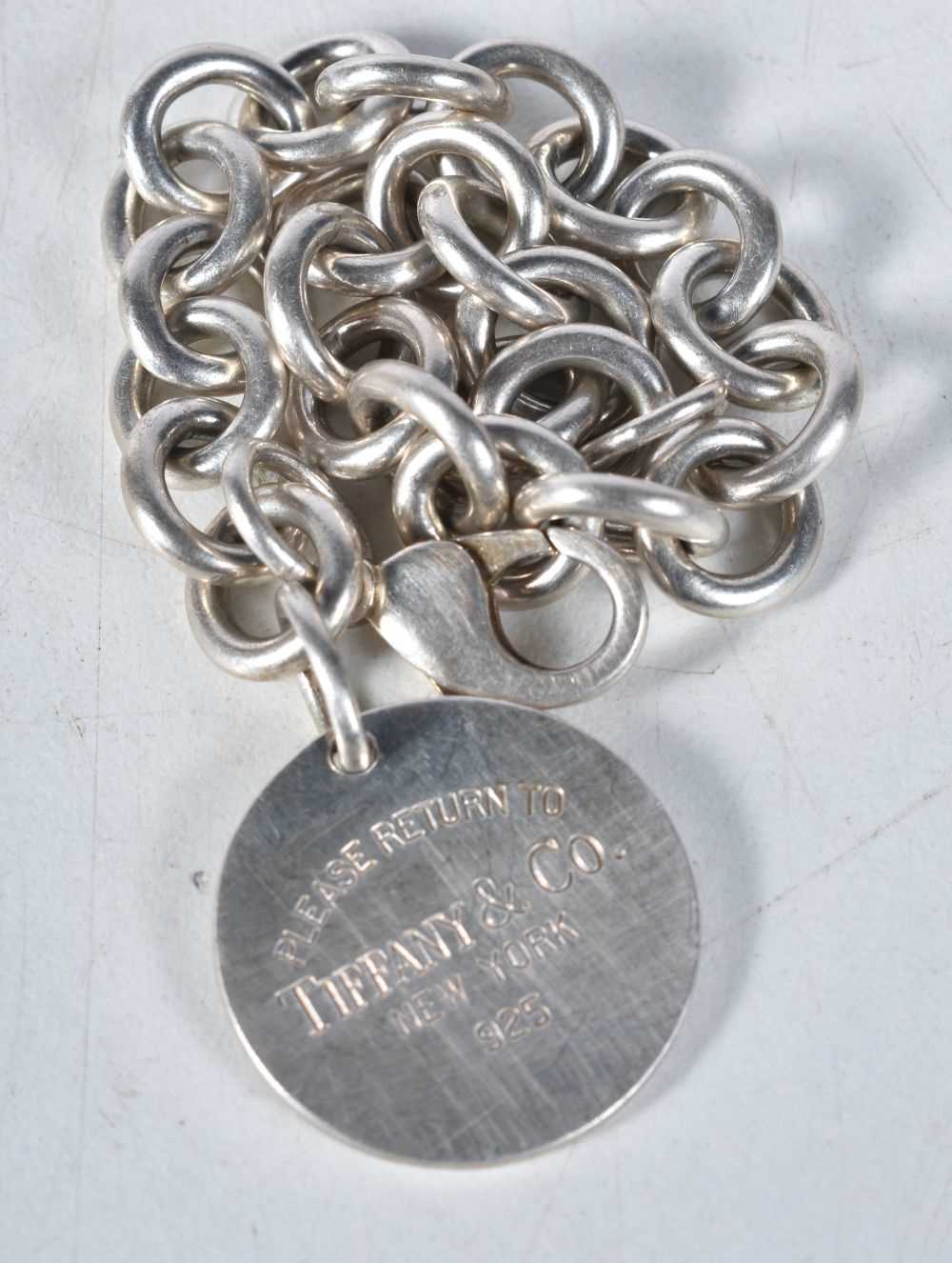 Silver belcher link bracelet with round tag by designer Tiffany & Co. Stamped 925 Tiffany, length