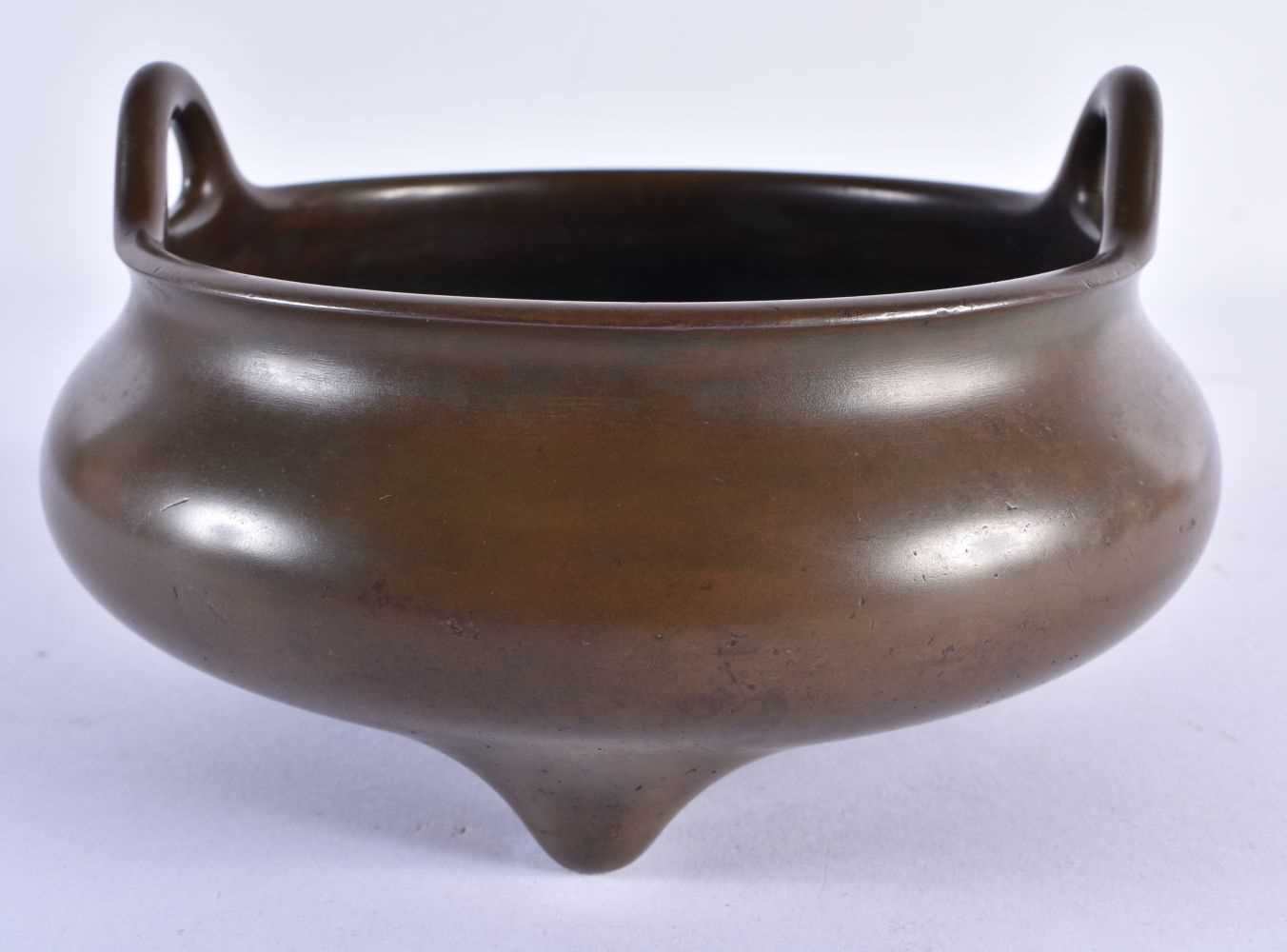 A RARE CHINESE QING DYNASTY TWIN HANDLED BRONZE CENSER bearing unusual studio mark to base. 2378
