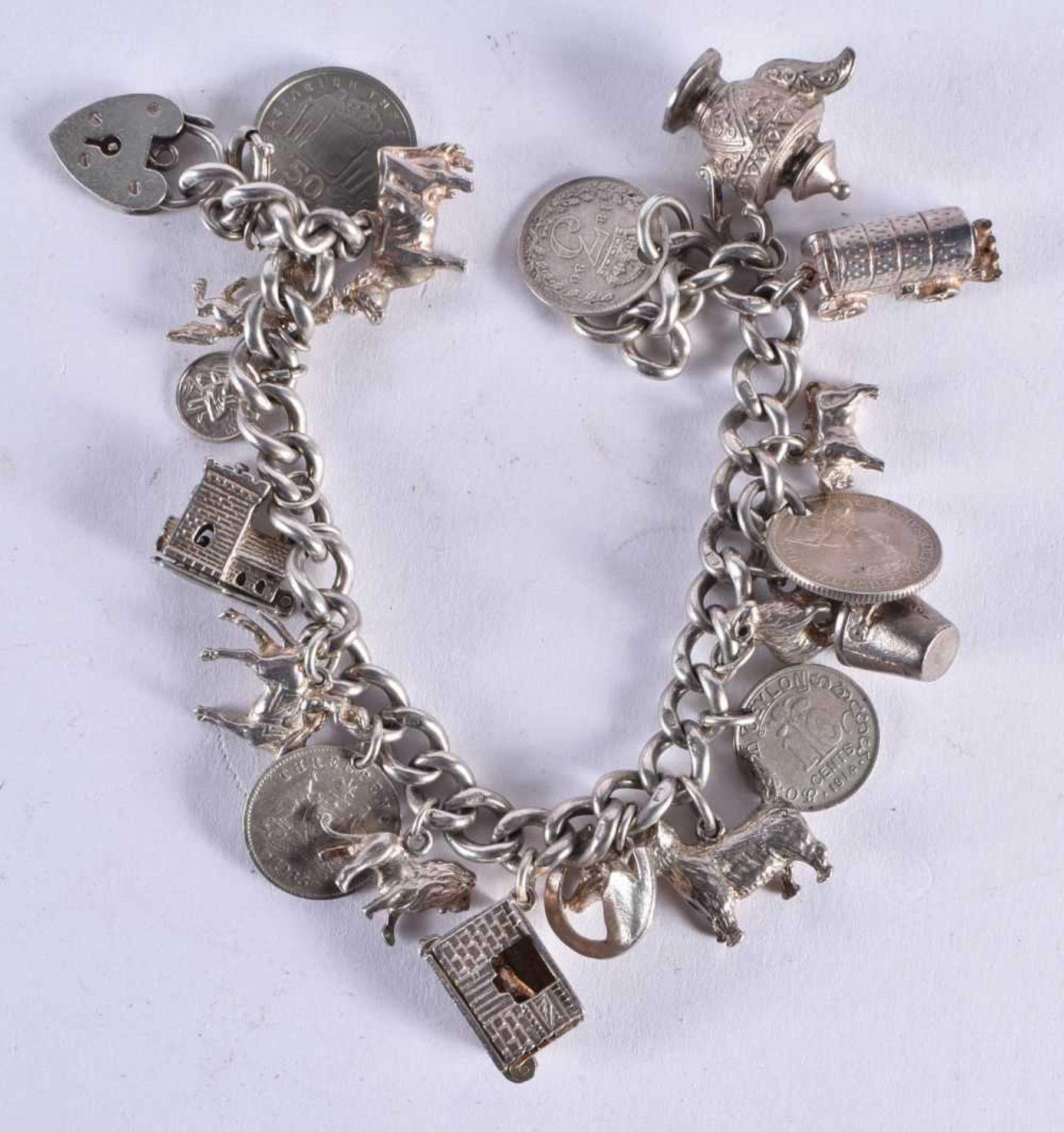 A SILVER CHARM BACELET. 74.6 grams. 20 cm wide.