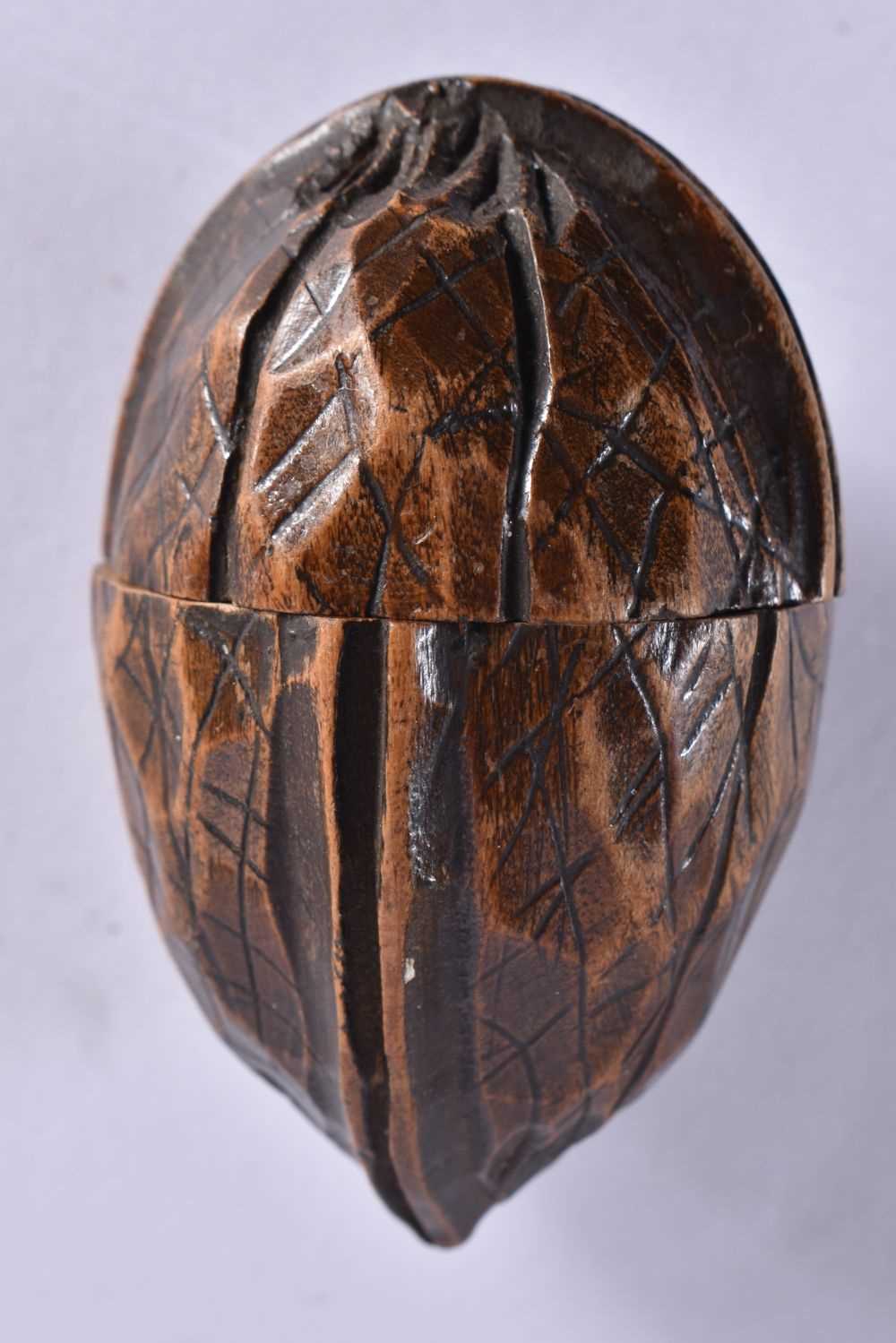 AN EXTREMELY RARE ANTIQUE CARVED NUT GLOBE the body rotating to reveal a tiny pocket globe. Nut 6 cm - Image 2 of 20