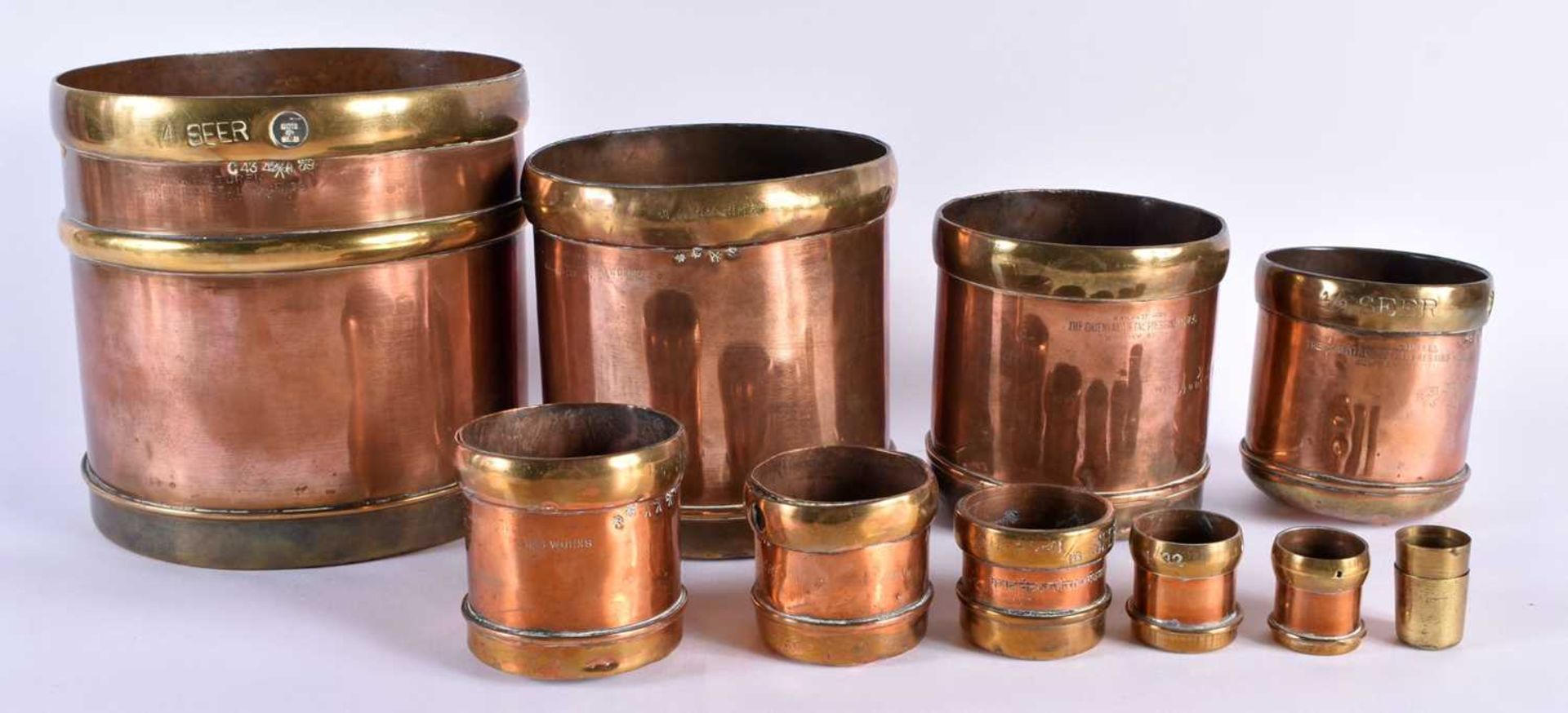A SET OF ANTIQUE COPPER AND BRASS MEASURES stamped Punjab Metal Works. Largest 17 cm x 17 cm. (qty)