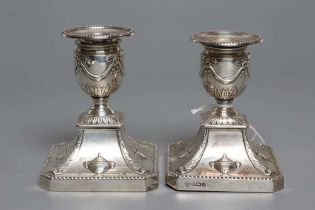 A COMPOSITE PAIR OF EDWARDIAN SILVER DWARF CANDLESTICKS, maker Hawkesworth, Eyre & Co., Sheffield