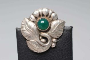 A GEORG JENSEN SILVER BROOCH similar to the previous lot inset with a circular polished green