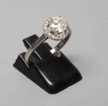 A DIAMOND CLUSTER RING, the central brilliant cut stone of approximately 0.80cts claw set to an open